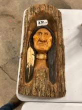 Indian chief carving on a log slab