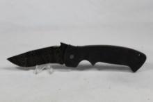 Large Liner Lock knife with 4 inch blade. Synthetic scales and pocket clip. China.