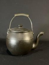 large black handled tea kettle, ceramic
