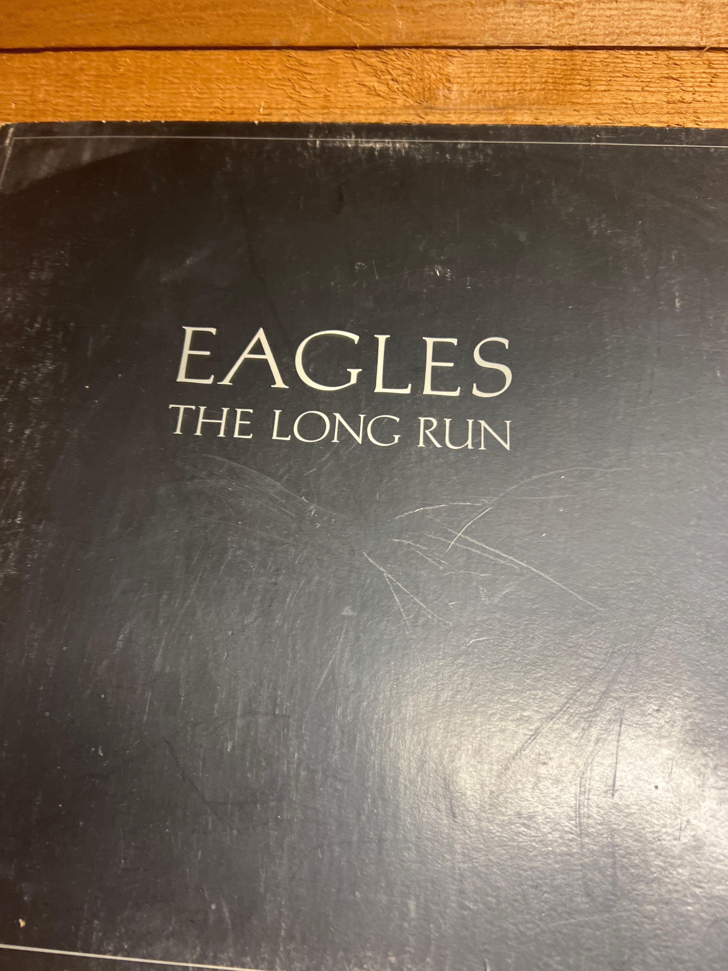 Contents of Shelf - 2 Clocks, Picture, Eagles Record, and Eric Clapton Record