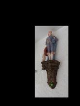 Wall sconce with figurine