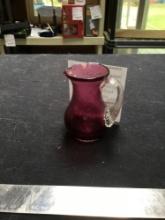 vintage cranberry glass pitcher with plied handle, marked on bottom