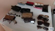 Lot of reading glasses and sunglasses