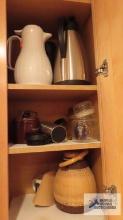 Krups coffee maker and coffee carafes and etc. in kitchen cabinet