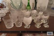 Variety of drink glasses with bulbous bases and other crystal white glasses