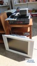 Decorative wooden stand. Emerson flat screen TV/ DVD player. Magnavox VHS player....Sony DVD player.