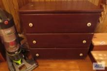 three drawer wooden chest in basement