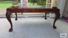 Antique mahogany coffee table with ball and claw feet and glass insert. Glass has chip on edge