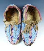 Pair of beautifully beaded Moccasins in good condition for age. Each has slight bead loss.