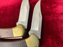 Pair of Vintage Buck Folding Knives, models 112 & 432 w/ Leather Sheaths