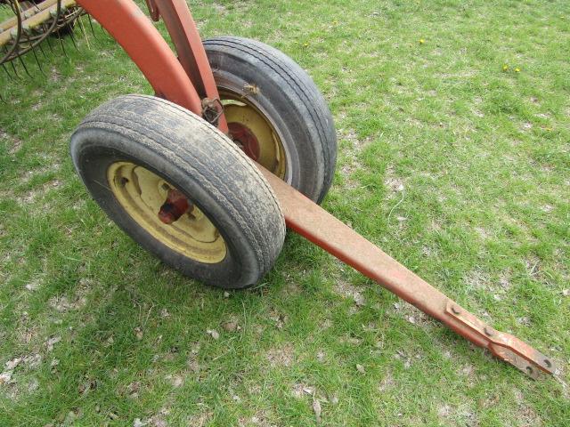 147. NEW HOLLAND 256 9 FT. PARALLEL BAR RAKE WITH HITCH WHEEL