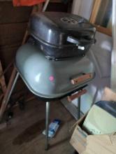 (SHED) LOT OF (2) CHARCOAL GRILLS. ONE IS A SMALL BLACK GRILL WITH NO LEGS. THE OTHER IS GRAY MECO