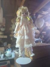 (GAR) Blonde Haired and Brown Eyed Porcelain Doll Wearing a Peach Dress with White Lace Ruffles,