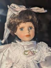 (GAR) Brown Haired and Blue Eyed Porcelain Doll Wearing a White Dress with Matching Hair Bow,