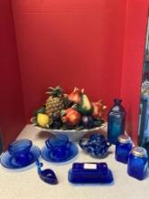 Cobalt blue glassware, and a ceramic fruit basket